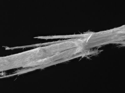 Close-up view of asbestos fibers under a microscope, showcasing their fibrous structure that posed significant health risks.