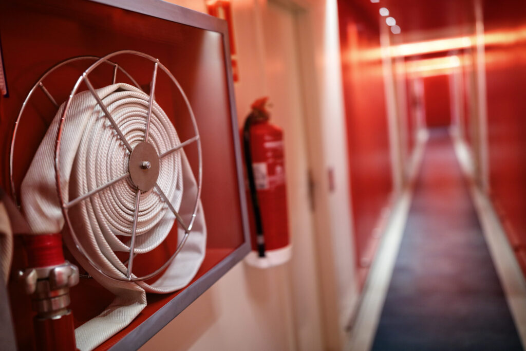 Fire extinguisher in corridor symbolising UK fire safety and PFAS foam concerns