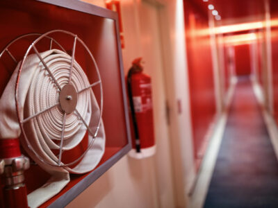 Fire extinguisher in corridor symbolising UK fire safety and PFAS foam concerns